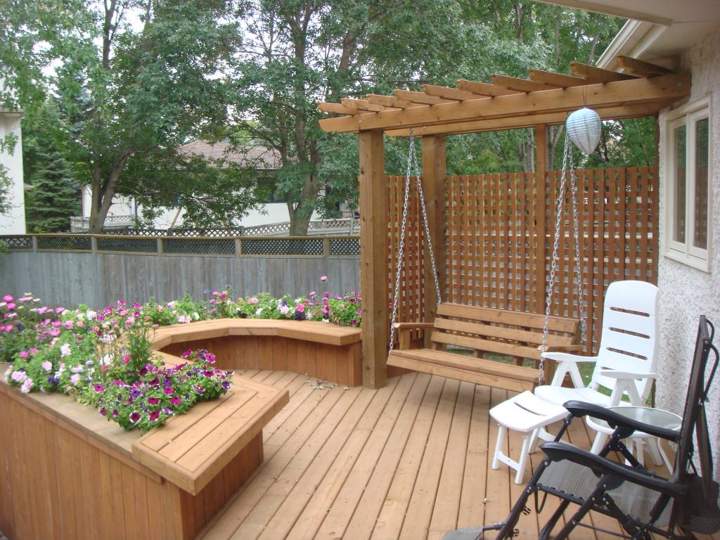 Deck, swing, pergola and built-in planter box  The Lawn Salon