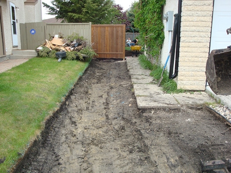 Regrading to improve drainage from back yard.