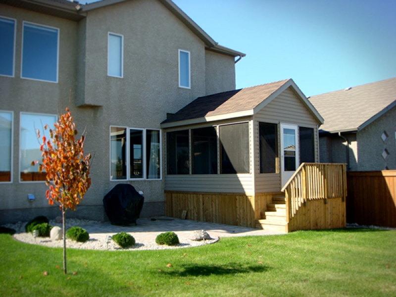 Screened room addition at back of house