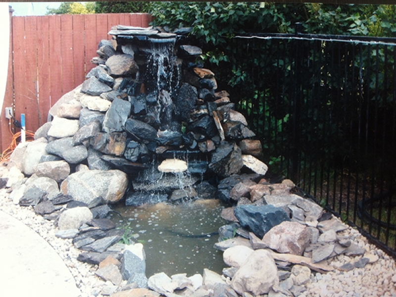 Tall custom waterfall built onto wooden substructure.