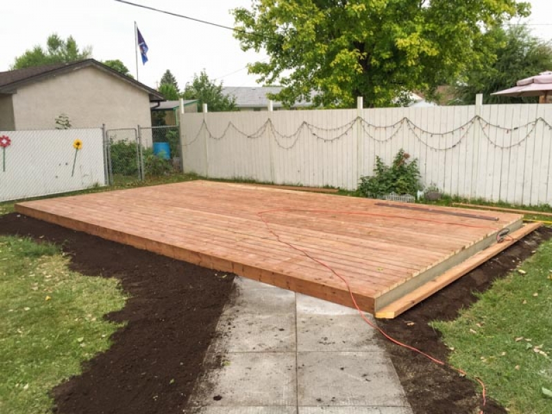 Used patio block re-installation and new ground-level deck in treated brown