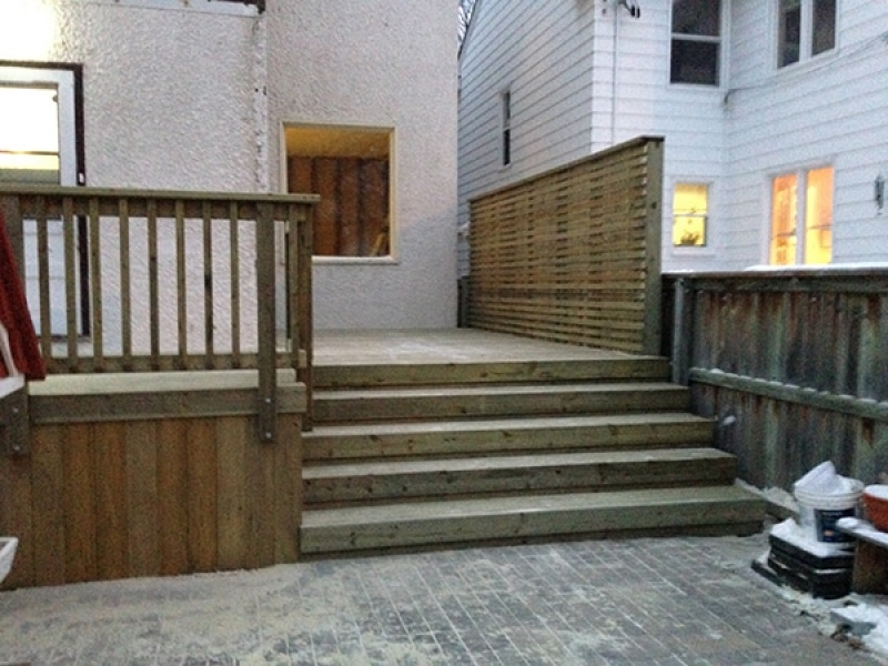 Treated green deck with privacy wall and piles for future hot tub enclosure