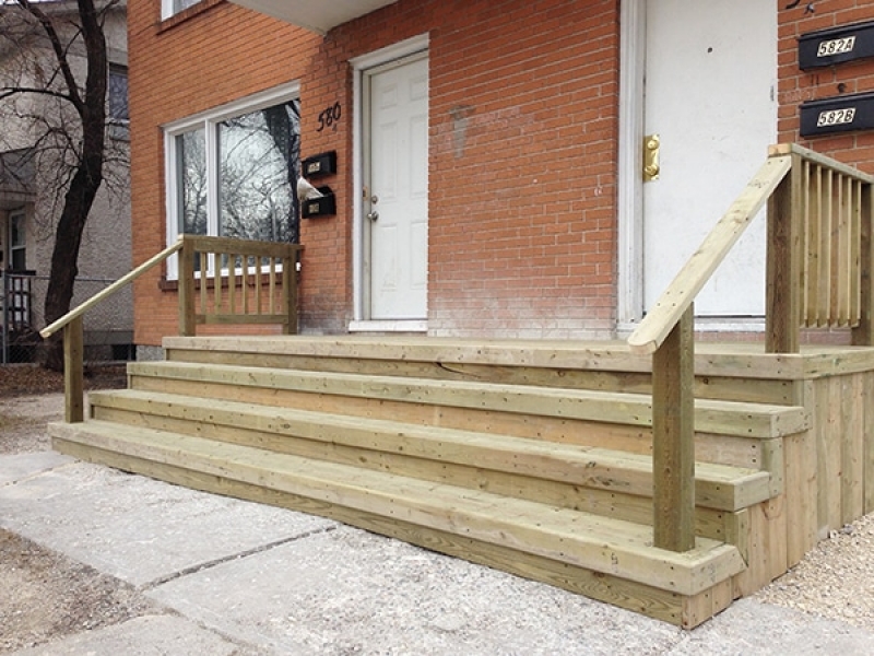 Large treated green front landing and stairs for duplex