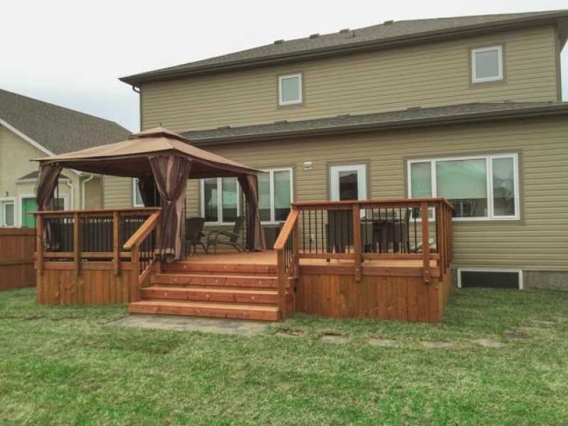 Grading and treated brown deck at rear of new house