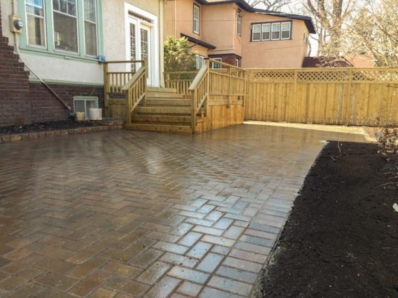 Treated green deck and fence with Holland paving stone patio in Antique Brown (AOW)