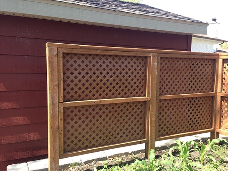 Natural wood mulch, sod, shed with Hardi-board siding, composite deck