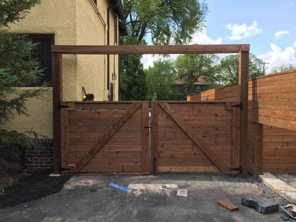 Treated brown swinging vehicle gate