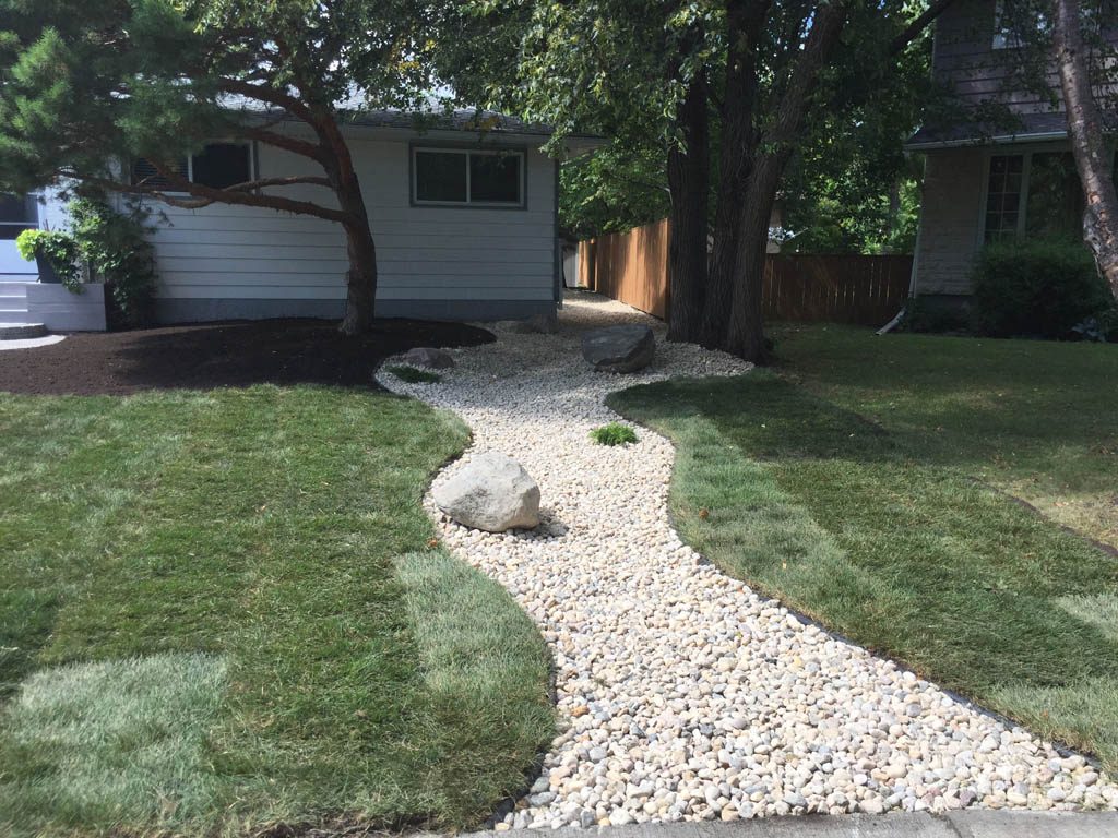 Complete yard re-grading with Roman paver walks, dry streambed, sod, etc