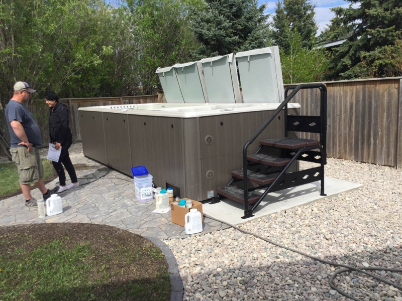 Swim spa pad, large window wells, re-grading, flagstone pathway, and decorative stone