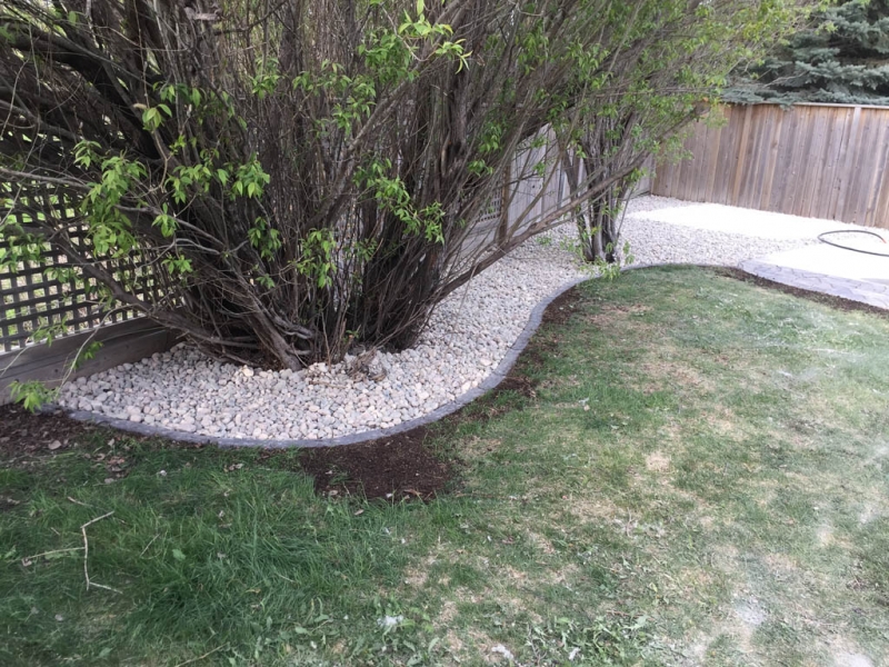 Swim spa pad, large window wells, re-grading, flagstone pathway, and decorative stone