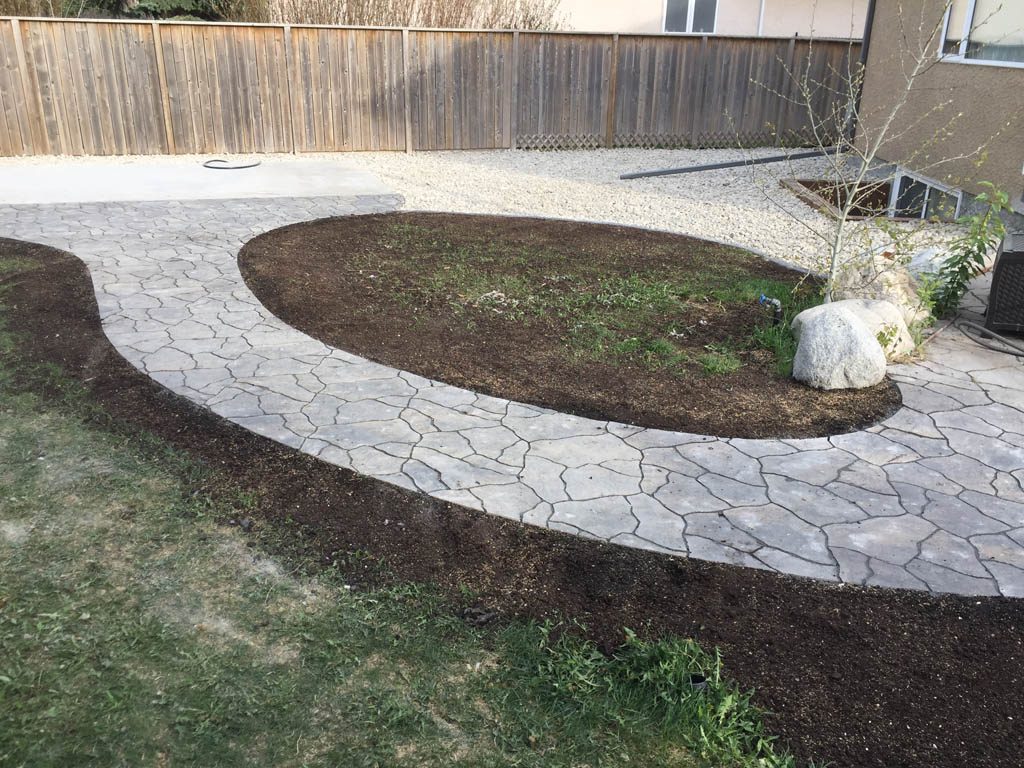 Swim spa pad, large window wells, re-grading, flagstone pathway, and decorative stone