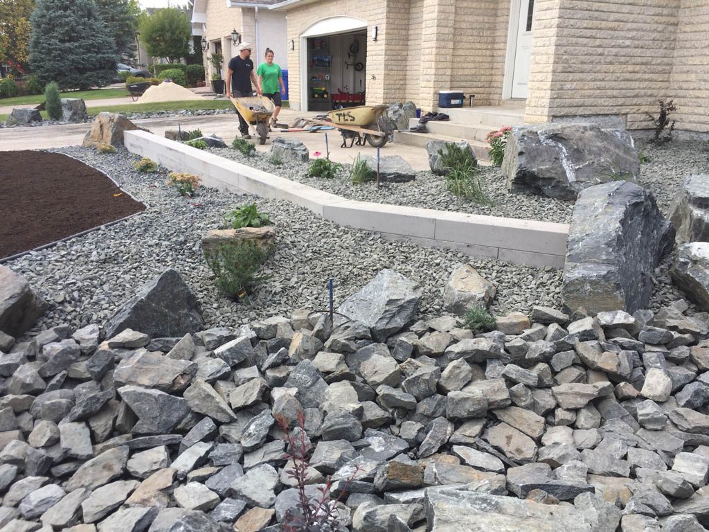 Front yard renovation with Architextures retaining wall, black granite, plants, sod