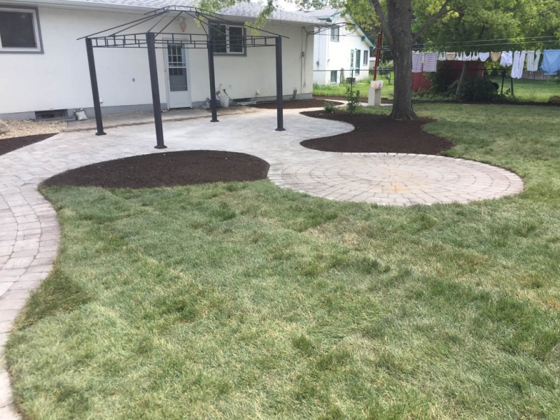 Complete yard re-grading with Roman paver walks, dry streambed, sod, etc