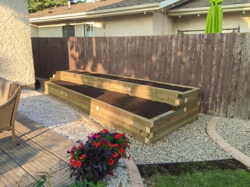 Two-tier wooden planter with treated green 4x4s