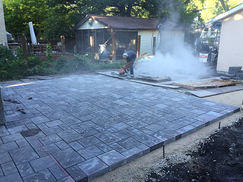 Navarro patio in Sierra Grey adjacent to treated green deck around swim spa