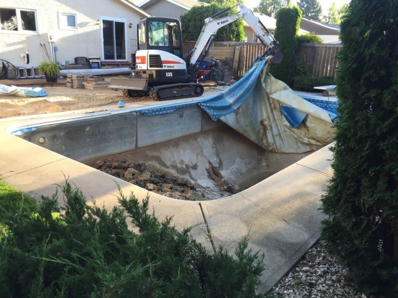 Liner and concrete being removed from in-ground pool