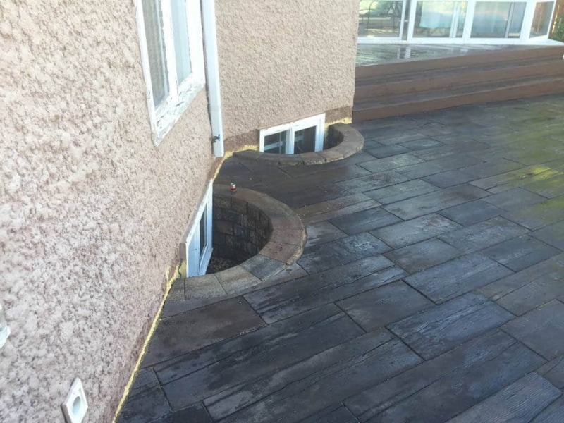 Bridgewood slab patio in cedar brown with Trex composite stairs and treated brown gazebo roof