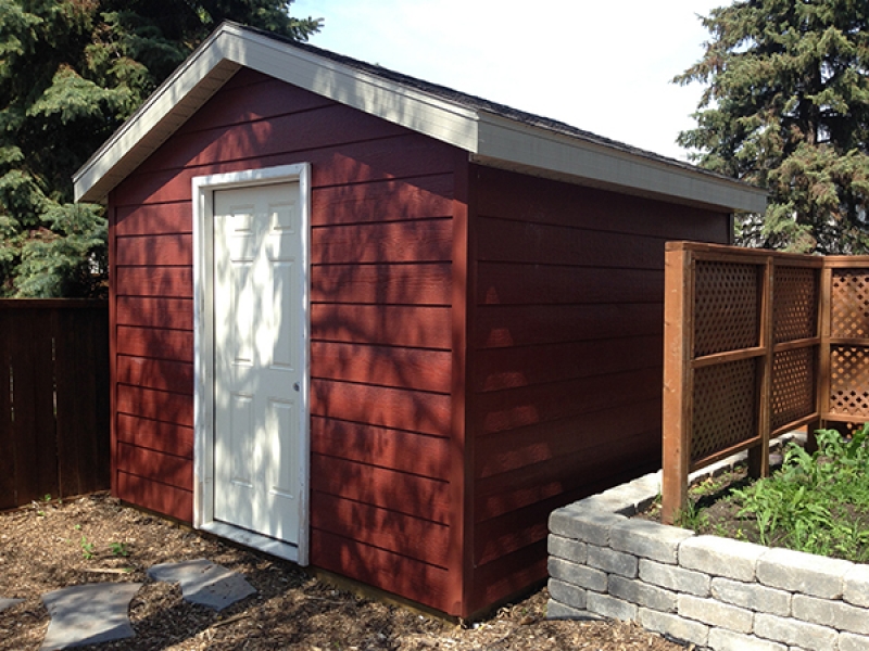 Natural wood mulch, sod, shed with Canexel siding, composite deck, Roman Paving Stones and Retaining Walls, Treated Brown Fencing.