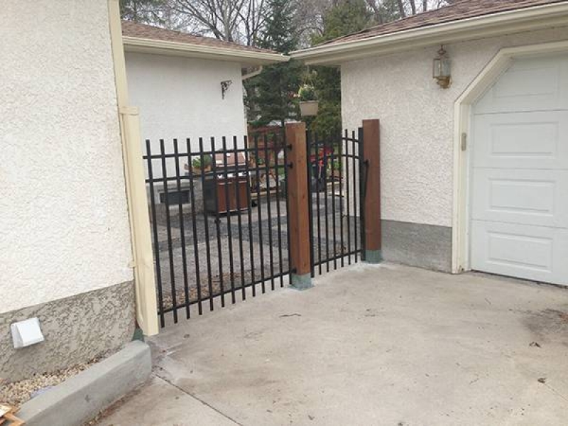 Black ornamental fence and gate with treated brown 6x6 posts (fences)