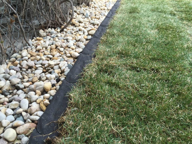 Charcoal Granite Edger separating grass and riverwash