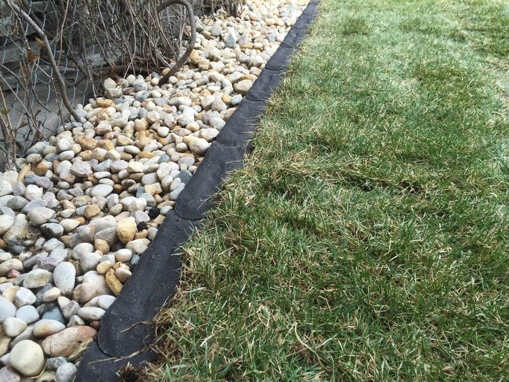 Charcoal Granite Edger separating grass and riverwash (low maintenance gardens)