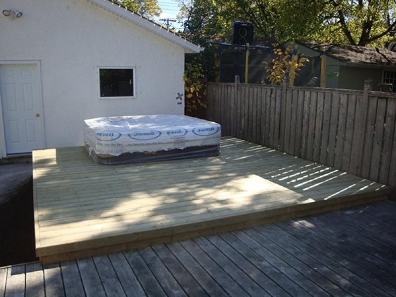 Hot tub pad and treated green deck added to existing deck