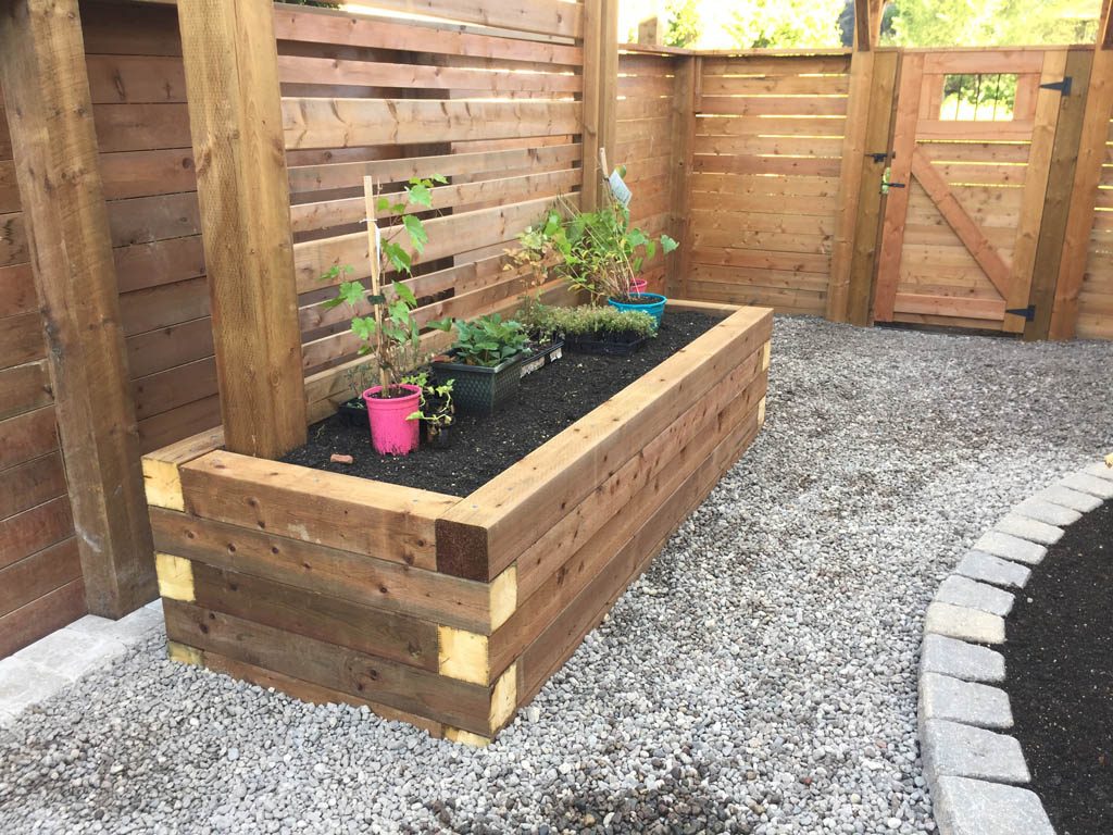 Treated brown pergola with hanging bench, fixed bench, Roman paving stones, planter with trellis, etc