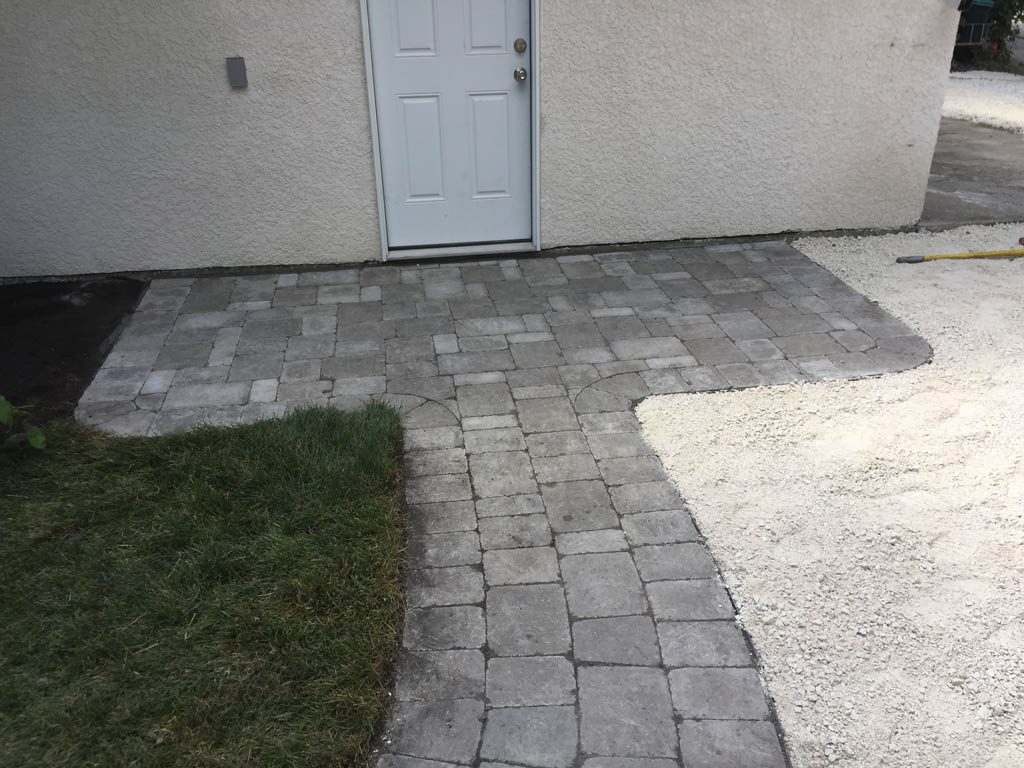 Complete yard re-grading with Roman paver walks, dry streambed, sod, etc