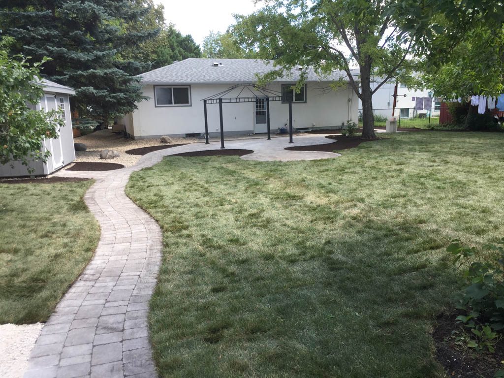 Complete yard re-grading with Roman paver walks, dry streambed, sod, etc