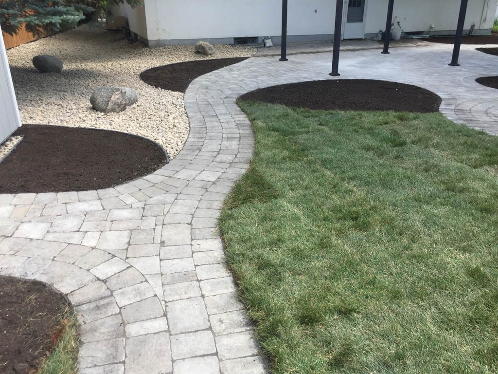 Complete yard re-grading with Roman paver walks, dry streambed, sod, etc