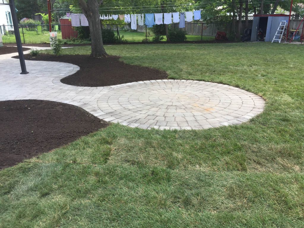 Complete yard re-grading with Roman paver walks, dry streambed, sod, etc