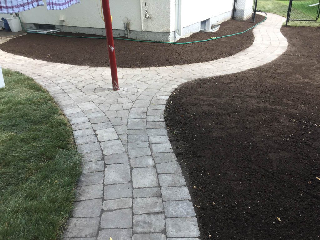 Complete yard re-grading with Roman paver walks, dry streambed, sod, etc