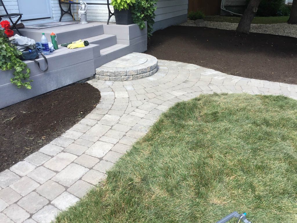 Complete yard re-grading with Roman paver walks, dry streambed, sod, etc