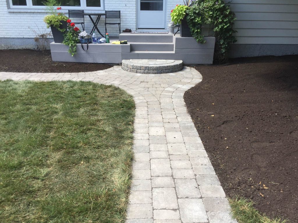 Complete yard re-grading with Roman paver walks, dry streambed, sod, etc