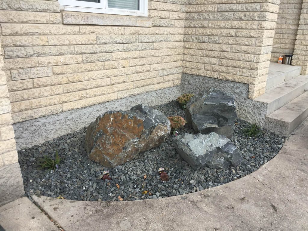 Front yard renovation with Architextures retaining wall, black granite, plants, sod