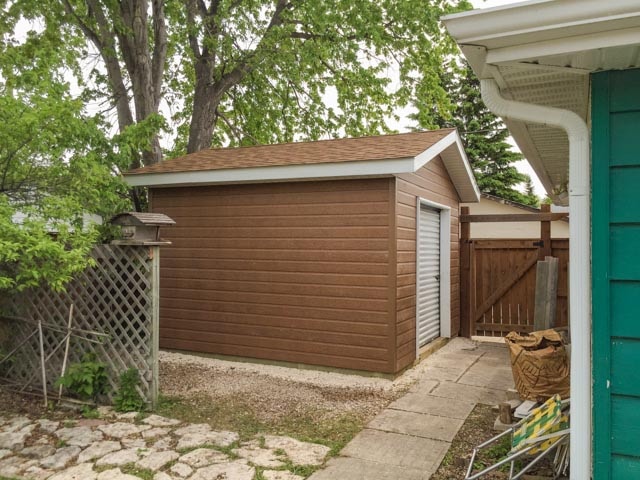 Shed with Canexel siding and roll-up door | The Lawn Salon