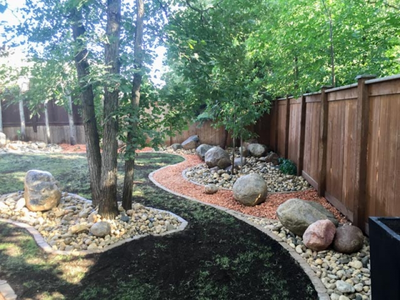 Rock garden with red shale, riverwash,fieldstone boulders, bordered with i-con edger