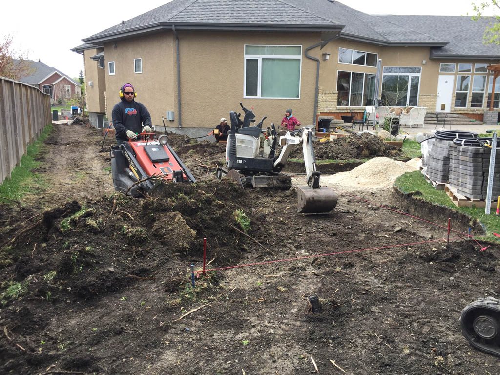 Swim spa pad, large window wells, re-grading, flagstone pathway, and decorative stone