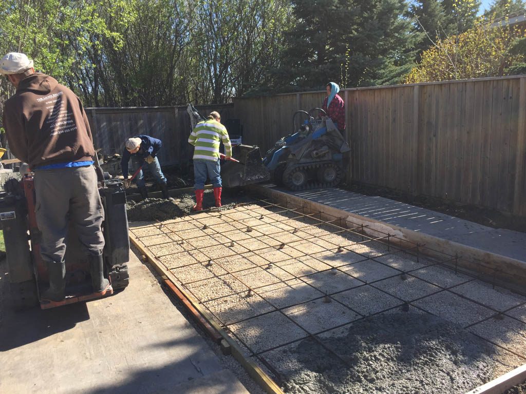 Swim spa pad, large window wells, re-grading, flagstone pathway, and decorative stone