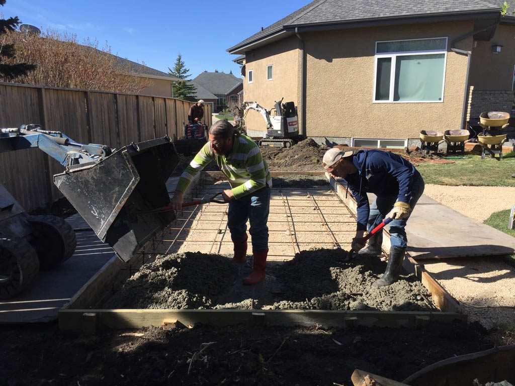 Swim spa pad, large window wells, re-grading, flagstone pathway, and decorative stone