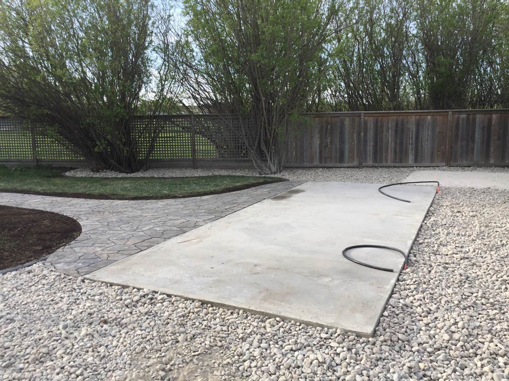 Swim spa pad, large window wells, re-grading, flagstone pathway, and decorative stone