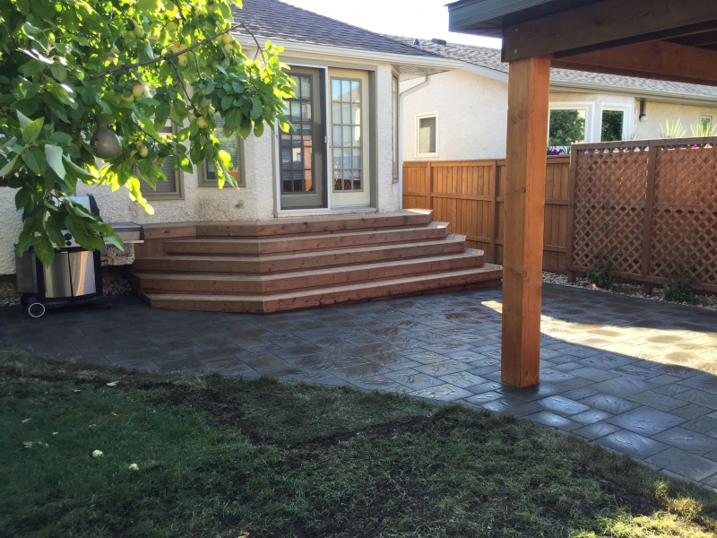 Navarro paving stone patio in Sierra Grey with treated brown stairs and gazebo roof