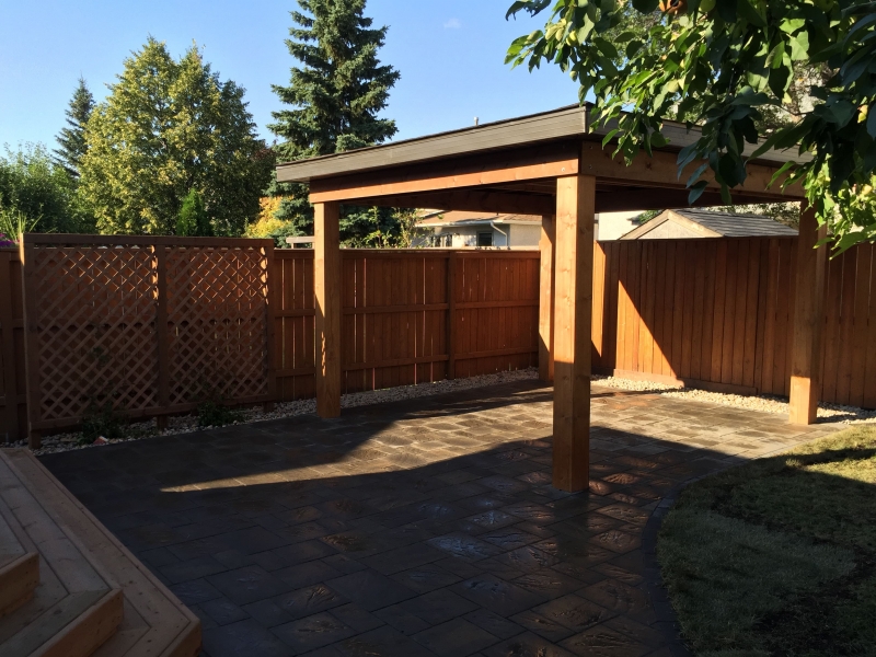 Navarro paving stone patio in Sierra Grey with treated brown stairs and gazebo roof