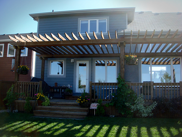 Treated brown rear deck covered with a pergola (decks, outdoor wood structures).jpg