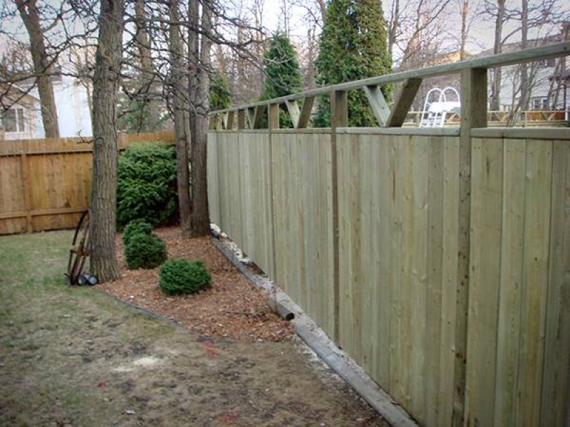 Treated green fence with custom v-shaped top insets (fence)