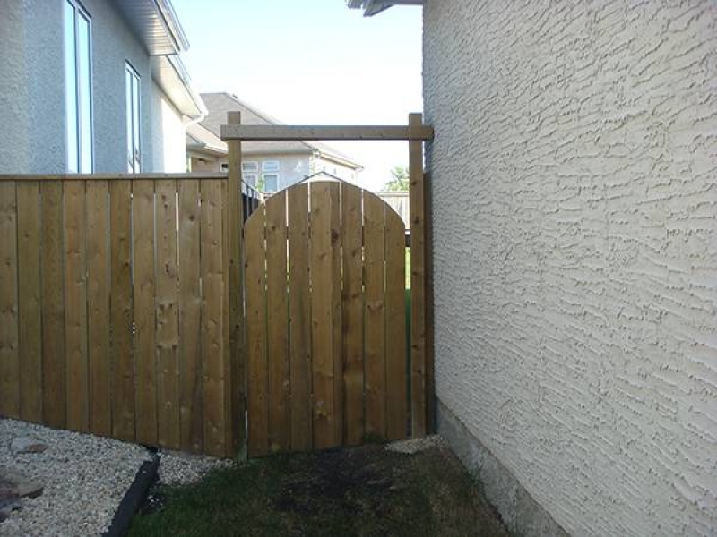 Treated green gate with rounded top and crossbar (fences)