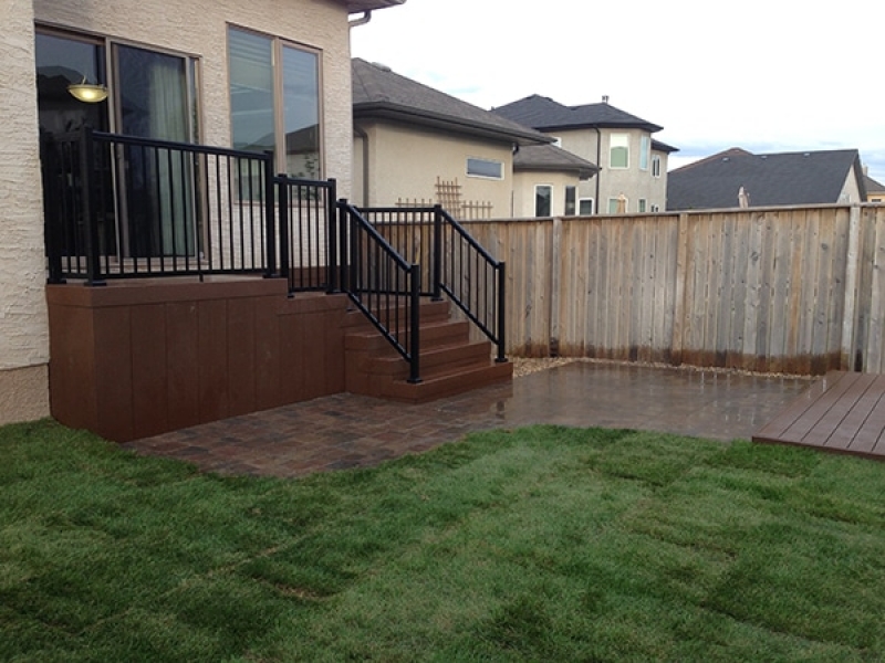 Composite deck, retaining wall window wells, patio, sod